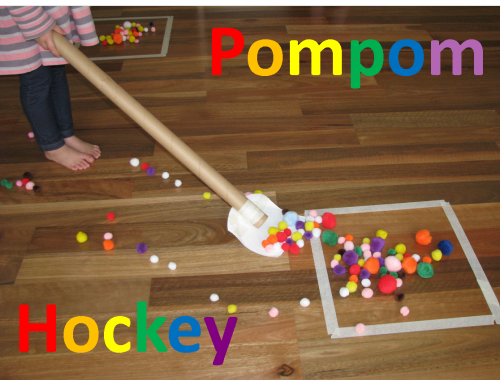 Child playing pom pom hockey