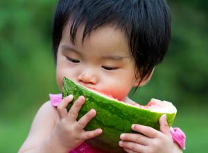 Child eating watermelon.
