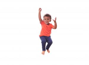 Child jumping in the air and twisting.
