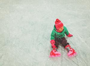 Child on ice rink wearing skates