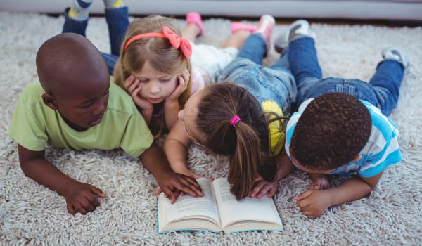 Kids reading a book together