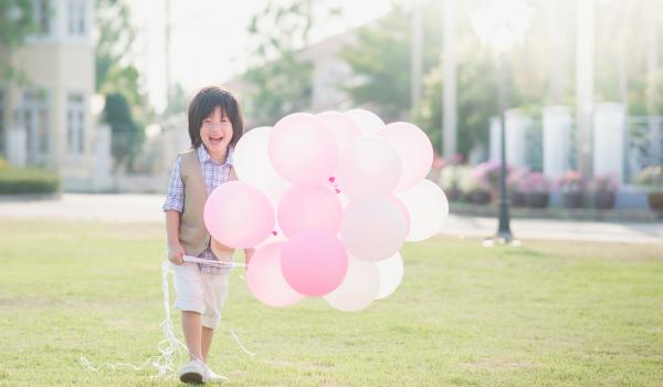 Child with pink balloons