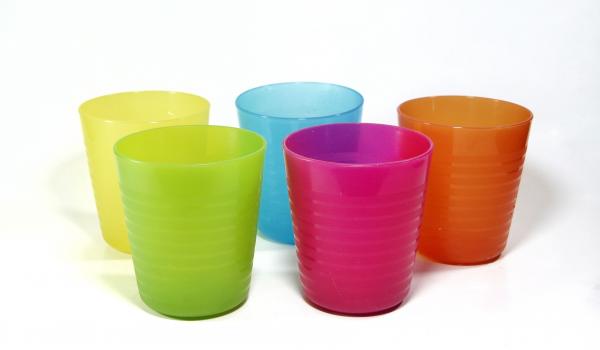Colourful plastic cups on a white floor and background.