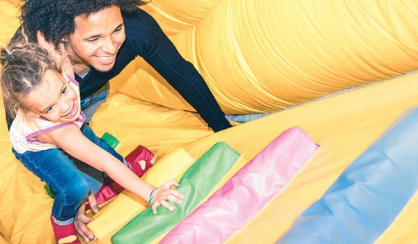 Adult and child climbing in a playground