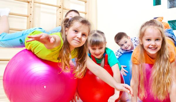 Children rolling on exercise balls