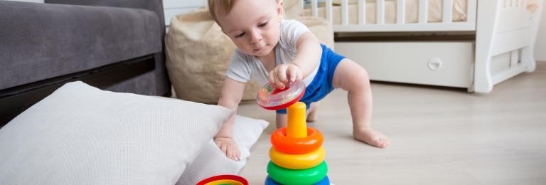 Infant developing movement skills of reaching and crawling