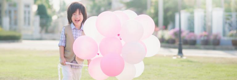 Child with pink balloons
