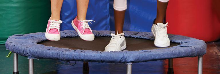 Children's feet jumping on a trampoline